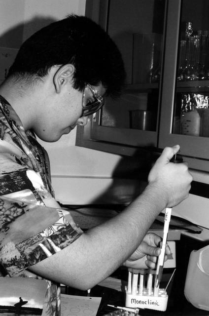 High school students screen crystals of various proteins that are part of the ground-based work that supports Alexander McPherson's protein crystal growth experiment. The students also prepared and stored samples in the Enhanced Gaseous Nitrogen Dewar, which was launched on the STS-98 mission for delivery to the ISS. The crystals grown on the ground will be compared with crystals grown in orbit. Participants include Joseph Negron (shown), of Terry Parker High School, Jacksonville, Florida; Megan Miskowski, of Ridgeview High School, Orange Park, Florida; and Sam Swank, of Fletcher High School, Neptune Beach, Florida. The proteins are placed in plastic tubing that is heat-sealed at the ends, then flash-frozen and preserved in a liquid nitrogen Dewar. Aboard the ISS, the nitrogen will be allowed to evaporated so the samples thaw and then slowly crystallize. They will be analyzed after return to Earth. Photo credit: NASA/Marshall Space Flight Center.