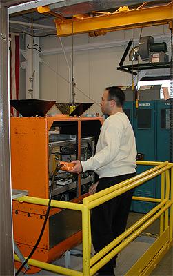 The first NASA Dropping In a Microgravity Environment (DIME) student competition pilot project came to a conclusion at the Glenn Research Center in April 2001. The competition involved high-school student teams who developed the concept for a microgravity experiment and prepared an experiment proposal. The two student teams - COSI Academy, sponsored by the Columbus Center of Science and Industry, and another team from Cincinnati, Ohio's Sycamore High School, designed a microgravity experiment, fabricated the experimental apparatus, and visited NASA Glenn to operate their experiment in the 2.2 Second Drop Tower. Here Jose Carrion, a lab mechanic with AKAC, starts the orange-colored drag shield, and the experiment apparatus inside, on the hoist upward to the control station at the top of the drop tower. This image is from a digital still camera; higher resolution is not available.