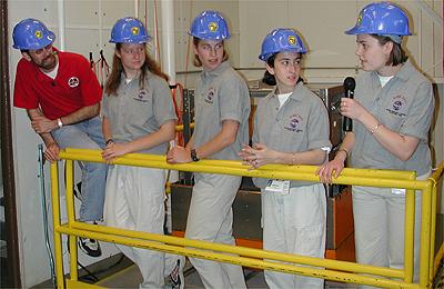 The first NASA Dropping In a Microgravity Environment (DIME) student competition pilot project came to a conclusion at the Glenn Research Center in April 2001. The competition involved high-school student teams who developed the concept for a microgravity experiment and prepared an experiment proposal. The two student teams - COSI Academy, sponsored by the Columbus Center of Science and Industry, and another team from Cincinnati, Ohio's Sycamore High School, designed a microgravity experiment, fabricated the experimental apparatus, and visited NASA Glenn to operate their experiment in the 2.2 Second Drop Tower. Here students from Sycamore High School in Cincinnati, Ohio, talk with Dr. Dennis Stocker, one of Glenn's lead microgravity scientists, about the uses of the drop tower. This image is from a digital still camera; higher resolution is not available.