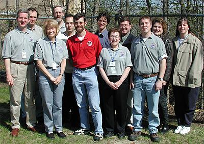 The first NASA Dropping In a Microgravity Environment (DIME) student competition pilot project came to a conclusion at the Glenn Research Center in April 2001. The competition involved high-school student teams who developed the concept for a microgravity experiment and prepared an experiment proposal. The two student teams - COSI Academy, sponsored by the Columbus Center of Science and Industry, and another team from Cincinnati, Ohio's Sycamore High School, designed a microgravity experiment, fabricated the experimental apparatus, and visited NASA Glenn to operate their experiment in the 2.2 Second Drop Tower. NASA and contractor personnel who conducted the DIME activity with the students. Shown (L-R) are: Eric Baumann (NASA, 2.2-second Drop Tower Facility manager), Daniel Dietrich (NASA) mentor for Sycamore High School team), Carol Hodanbosi (National Center for Microgravity Research; DIME staff), Richard DeLombard (NASA; DIME staff), Jose Carrion (GRC Akima, drop tower technician), Dennis Stocker (NASA; DIME staff), Peter Sunderland (NCMR, mentor for COSI Academy student team), Sandi Thompson (NSMR sabbatical teacher; DIME staff), Dan Woodard (MASA Microgravity Outreach Program Manager), Adam Malcolm (NASA co-op student; DIME staff), Carla Rosenberg (NCMR; DIME staff), and Twila Schneider (Infinity Technology; NASA Microgravity Research program contractor). This image is from a digital still camera; higher resolution is not available.