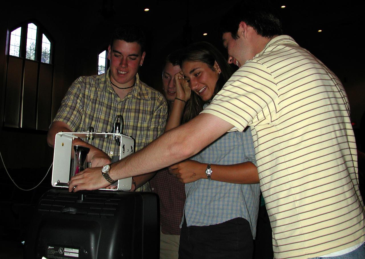 Marshall Space Flight Center employees visited DuPont Manual High School in Louisville, Kentucky. NASA's Mini Drop Tower was used to demonstrate free fall and a presentation was given on microgravity and the science performed in a microgravity environment. The visit coincided with the Pan-Pacific Basin Workshop on Microgravity Sciences held in Pasadena, California. Students experiment with the mini-drop tower. This image is from a digital still camera; higher resolution is not available.