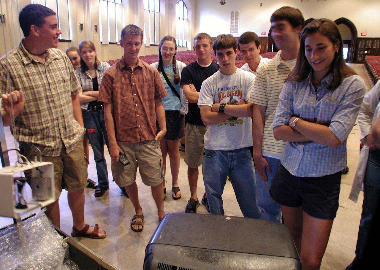 Marshall Space Flight Center employees visited DuPont Manual High School in Louisville, Kentucky. NASA's Mini Drop Tower was used to demonstrate free fall and a presentation was given on microgravity and the science performed in a microgravity environment. The visit coincided with the Pan-Pacific Basin Workshop on Microgravity Sciences held in Pasadena, California. Students watch the playback of video from the mini-drop tower. This image is from a digital still camera; higher resolution is not available.