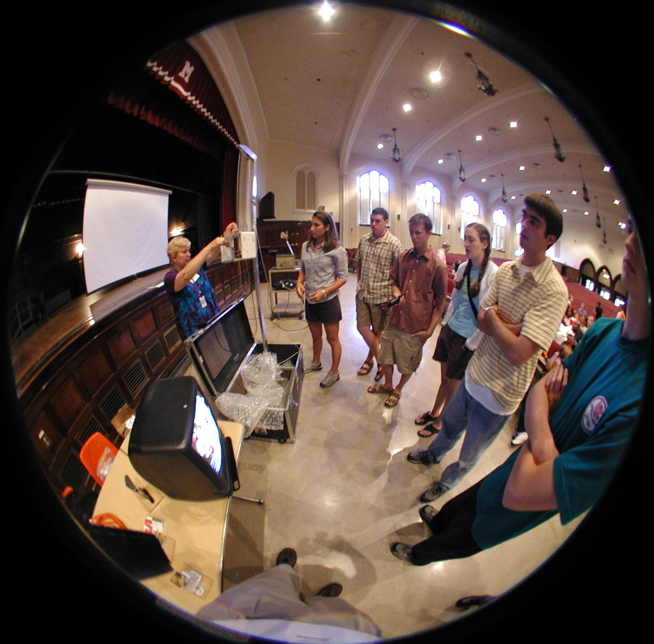 Marshall Space Flight Center employees visited DuPont Manual High School in Louisville, Kentucky. NASA's Mini Drop Tower was used to demonstrate free fall and a presentation was given on microgravity and the science performed in a microgravity environment. The visit coincided with the Pan-Pacific Basin Workshop on Microgravity Sciences held in Pasadena, California. Materials engineer Chris Cochrane explains the operation of the mini-drop tower. This image is from a digital still camera; higher resolution is not available.