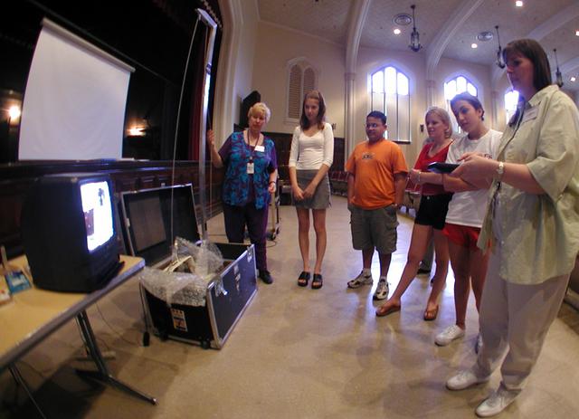 Marshall Space Flight Center employees visited DuPont Manual High School in Louisville, Kentucky. NASA's Mini Drop Tower was used to demonstrate free fall and a presentation was given on microgravity and the science performed in a microgravity environment. The visit coincided with the Pan-Pacific Basin Workshop on Microgravity Sciences held in Pasadena, California. Materials engineer Chris Cochrane explains the operation of the mini-drop tower. This image is from a digital still camera; higher resolution is not available.