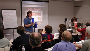 The arnual conference for the Educator Resource Center Network (ERCN) Coordinators was held at Glenn Research Center at Lewis Field in Cleveland, Ohio. The conference included participants from NASA's Educator Resource Centers located throughout the country. The Microgravity Science Division at Glenn sponsored a Microgravity Day for all the conference participants. Twila Schneider of Infinity Technology, a NASA contractor, explains the basics of building a glovebox mockup from a copier paper box. This image is from a digital still camera; higher resolution is not available.