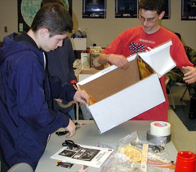 Students in the Young Astronaut Program at the Coca-Cola Space Science Center in Columbus, GA, constructed gloveboxes using the new NASA Student Glovebox Education Guide. The young astronauts used cardboard copier paper boxes as the heart of the glovebox. The paper boxes transformed into gloveboxes when the students pasted poster-pictures of an actual NASA microgravity science glovebox inside and outside of the paper boxes. The young astronauts then added holes for gloves and removable transparent top covers, which completed the construction of the gloveboxes. This image is from a digital still camera; higher resolution is not available.