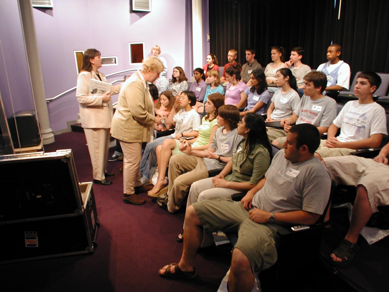 Students from DuPont Manual High School in Louisville, Kentucky participated in a video-teleconference during the Pan-Pacific Basin Workshop on Microgravity Sciences held in Pasadena, California. The event originated at the California Science Center in Los Angeles. The DuPont Manual students patched in to the event through the distance learning lab at the Louisville Science Center. Education coordinator Twila Schneider (left) of Infinity Technology and NASA materials engineer Chris Cochrane prepare students for the on-line workshop. This image is from a digital still camera; higher resolution is not available.