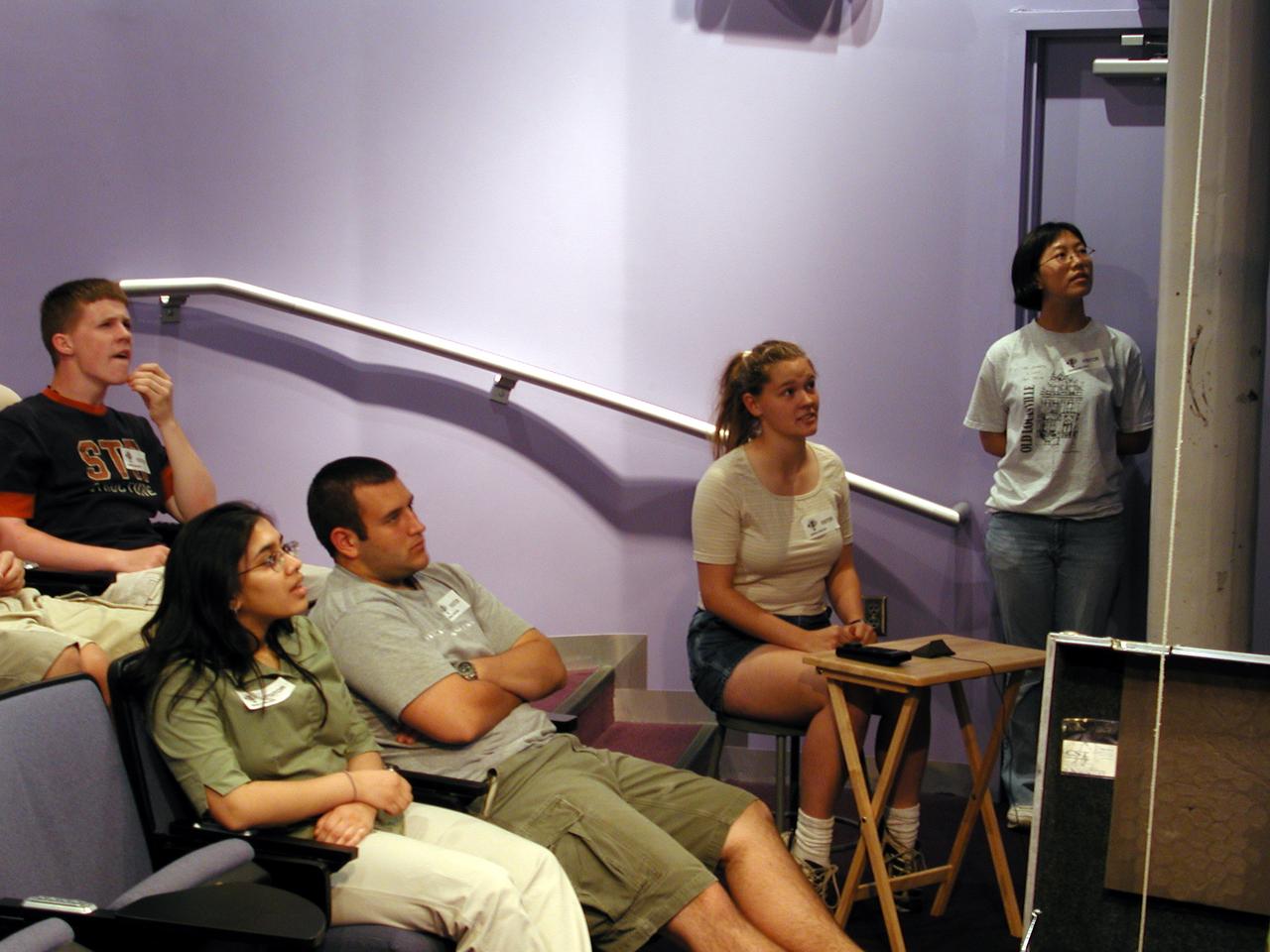 Suzarne Nichols (12th grade) from DuPont Manual High School in Louisville, Kentucky, asks a question of on of the on-line lecturers during the Pan-Pacific Basin Workshop on Microgravity Sciences held in Pasadena, California. The event originated at the California Science Center in Los Angeles. The DuPont Manual students patched in to the event through the distance learning lab at the Louisville Science Center. Jie Ma (grade 10, at right) waits her turn to ask a question. This image is from a digital still camera; higher resolution is not available.