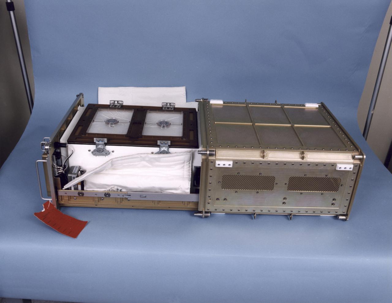 Biotechnology Refrigerator that preserves samples for use in (or after culturing in) the NASA Bioreactor. The unit is shown extracted from a middeck locker shell and with thermal blankets partially removed. The NASA Bioreactor provides a low turbulence culture environment which promotes the formation of large, three-dimensional cell clusters. The Bioreactor is rotated to provide gentle mixing of fresh and spent nutrient without inducing shear forces that would damage the cells. Due to their high level of cellular organization and specialization, samples constructed in the bioreactor more closely resemble the original tumor or tissue found in the body. The work is sponsored by NASA's Office of Biological and Physical Research. The bioreactor is managed by the Biotechnology Cell Science Program at NASA's Johnson Space Center (JSC). NASA-sponsored bioreactor research has been instrumental in helping scientists to better understand normal and cancerous tissue development. In cooperation with the medical community, the bioreactor design is being used to prepare better models of human colon, prostate, breast and ovarian tumors. Cartilage, bone marrow, heart muscle, skeletal muscle, pancreatic islet cells, liver and kidney are just a few of the normal tissues being cultured in rotating bioreactors by investigators.
