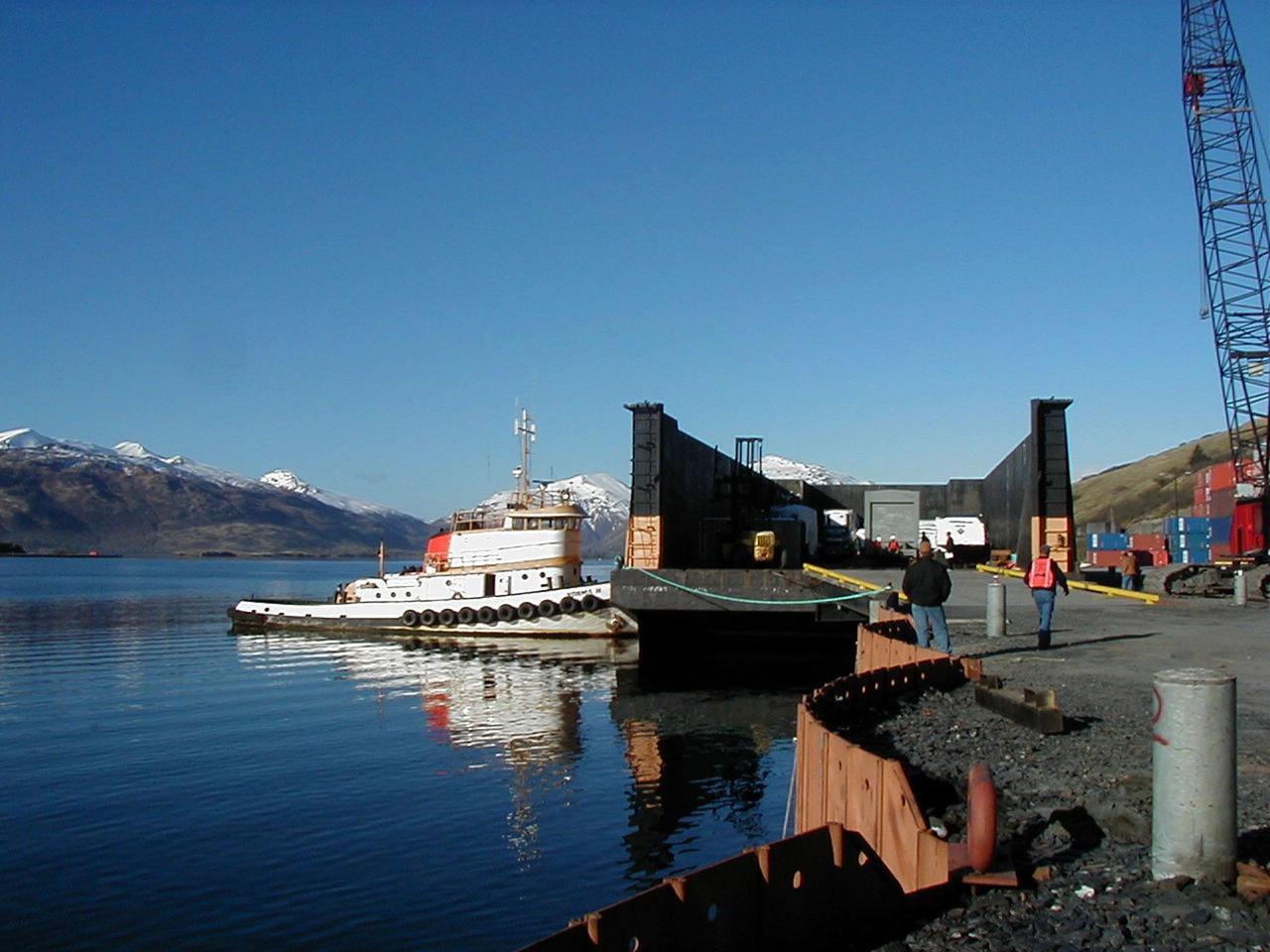 KODIAK ISLAND, Alaska -- A boat moves a ramp into place that will allow Castor 120, the first stage of the Athena 1 launch vehicle, to safely move onto the dock at Kodiak Island, Alaska, as preparations to launch Kodiak Star proceed.  The first orbital launch to take place from Alaska's Kodiak Launch Complex, Kodiak Star is scheduled to lift off on a Lockheed Martin Athena I launch vehicle on Sept. 17 during a two-hour window that extends from 5:00 to 7:00 p.m. ADT.  The payloads aboard include the Starshine 3, sponsored by NASA, and the PICOSat, PCSat and Sapphire, sponsored by the Department of Defense (DoD) Space Test Program.     