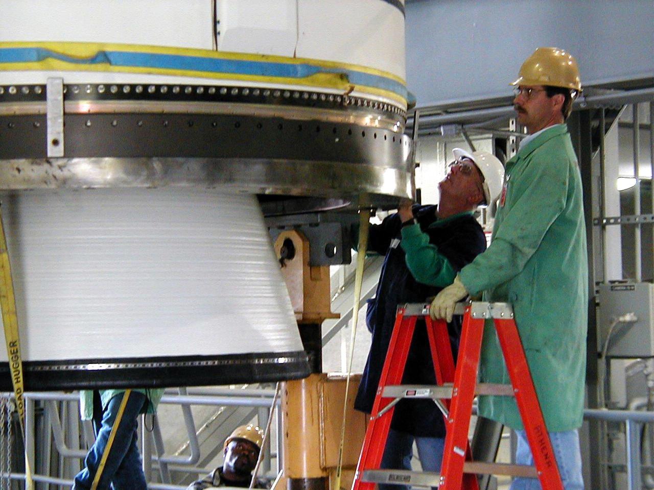 KODIAK ISLAND, Alaska -- Technicians inspect Castor 120, the first stage of the Athena 1 launch vehicle, at Kodiak Island, Alaska, as preparations to launch Kodiak Star proceed.  The first orbital launch to take place from Alaska's Kodiak Launch Complex, Kodiak Star is scheduled to lift off on a Lockheed Martin Athena I launch vehicle on Sept. 17 during a two-hour window that extends from 5:00 to 7:00 p.m. ADT.  The payloads aboard include the Starshine 3, sponsored by NASA, and the PICOSat, PCSat and Sapphire, sponsored by the Department of Defense (DoD) Space Test Program.  