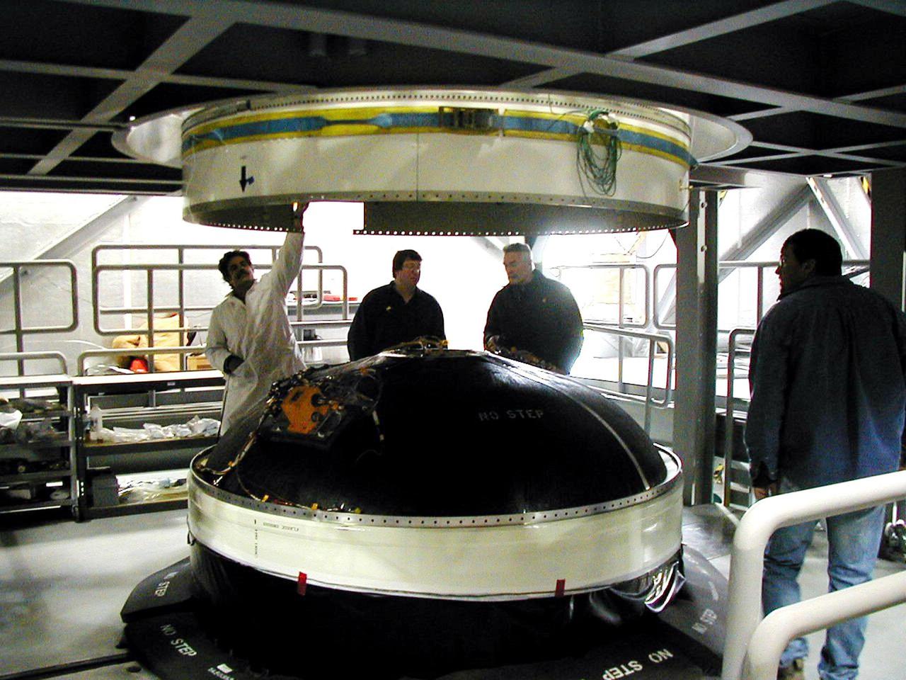 KODIAK ISLAND, Alaska -- Technicians lower the fueled Orbit Adjust Model (OAM), which navigates payloads into the correct orbit, onto Orbis 21D Equipment Section Boost Motor, the second stage of the Athena 1 launch vehicle, at the launch pad at Kodiak Island, Alaska, as preparations to launch Kodiak Star proceed. The first orbital launch to take place from Alaska's Kodiak Launch Complex, Kodiak Star is scheduled to lift off on a Lockheed Martin Athena I launch vehicle on Sept. 17 during a two-hour window that extends from 5 p.m. ADT. The payloads aboard include the Starshine 3, sponsored by NASA, and the PICOSat, PCSat and Sapphire, sponsored by the Department of Defense (DoD) Space Test Program.