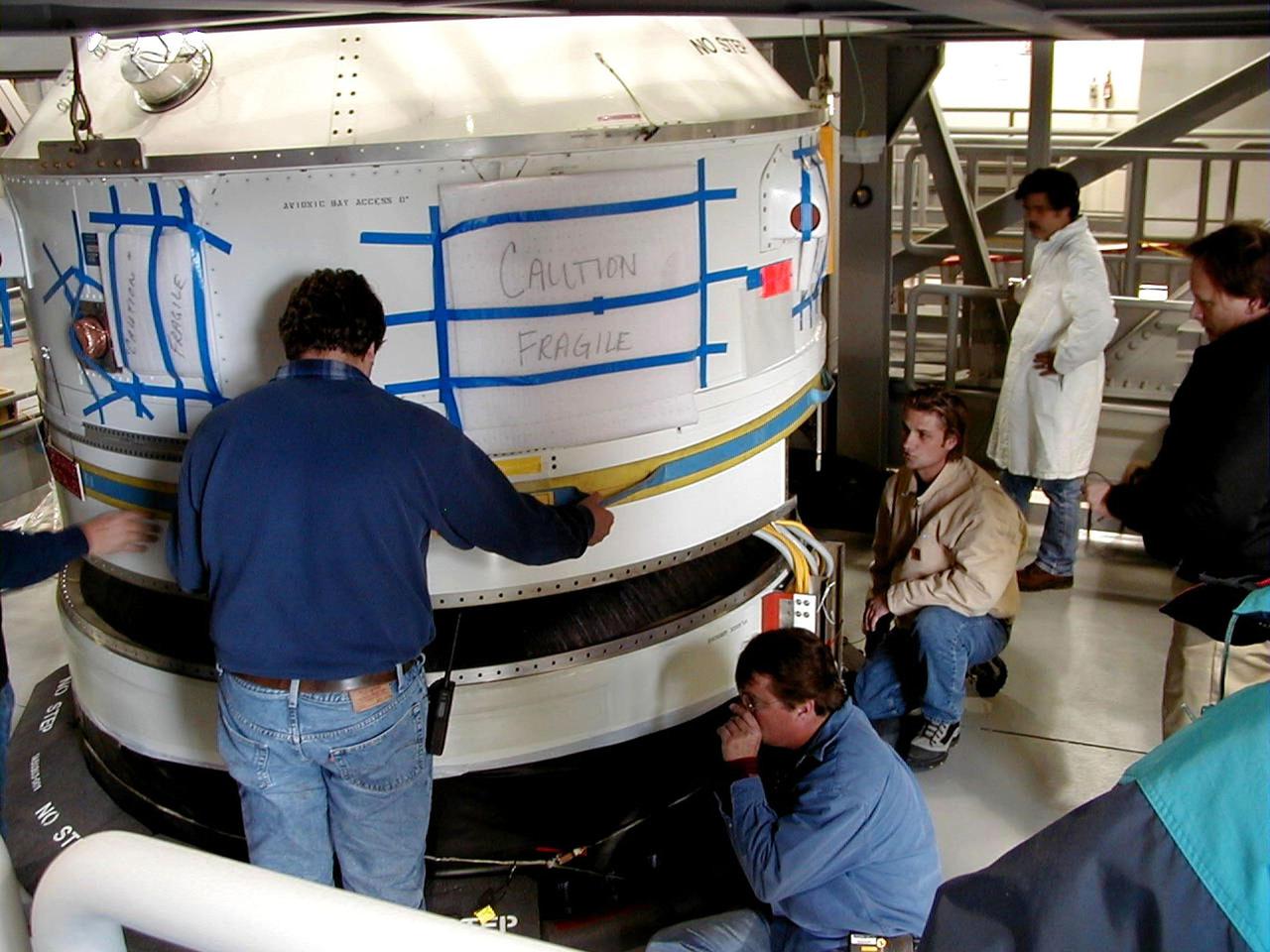KODIAK ISLAND, Alaska -- Technicians align the fueled Orbit Adjust Model (OAM), which navigates payloads into the correct orbit, onto Orbis 21D Equipment Section Boost Motor, the second stage of the Athena 1 launch vehicle, at the launch pad at Kodiak Island, Alaska, as preparations to launch Kodiak Star proceed. The first orbital launch to take place from Alaska's Kodiak Launch Complex, Kodiak Star is scheduled to lift off on a Lockheed Martin Athena I launch vehicle on Sept. 17 during a two-hour window that extends from 5:00 to 7:00 p.m. ADT. The payloads aboard include the Starshine 3, sponsored by NASA, and the PICOSat, PCSat and Sapphire, sponsored by the Department of Defense (DoD) Space Test Program.