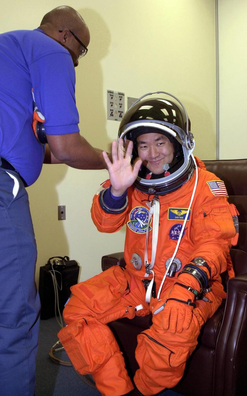 KENNEDY SPACE CENTER, Fla. -- STS-108 Mission Specialist Daniel M. Tani is happy to be suiting up for the second launch attempt of Space Shuttle Endeavour. The first attempt Dec. 4 was scrubbed due to poor weather conditions at KSC. The main goals of the mission are to carry the Expedition 4 crew to the International Space Station as replacement for Expedition 3; carry the Multi-Purpose Logistics Module Raffaello filled with water, equipment and supplies; and install thermal blankets over equipment at the base of the ISS solar wings. STS-108 is the final Shuttle mission of 2001 and the 107th Shuttle flight overall. It is the 12th flight to the Space Station. Launch is scheduled for 5:19 p.m. EST (22:19 GMT) Dec. 5, 2001, from Launch Pad 39B