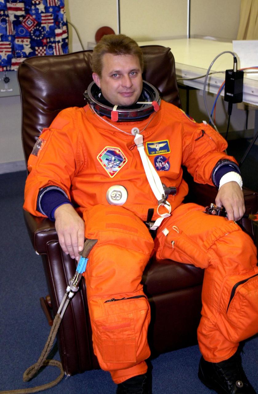 KENNEDY SPACE CENTER, Fla. -- Expedition 4 Commander Yuri Onufrienko gets ready in his launch and entry suit for the second launch attempt of Space Shuttle Endeavour on mission STS-108. The first attempt Dec. 4 was scrubbed due to poor weather conditions at KSC. The main goals of the mission are to carry the Expedition 4 crew to the International Space Station as replacement for Expedition 3; carry the Multi-Purpose Logistics Module Raffaello filled with water, equipment and supplies; and install thermal blankets over equipment at the base of the ISS solar wings. STS-108 is the final Shuttle mission of 2001 and the 107th Shuttle flight overall. Launch is scheduled for 5:19 p.m. EST (22:19 GMT) Dec. 5, 2001, from Launch Pad 39B