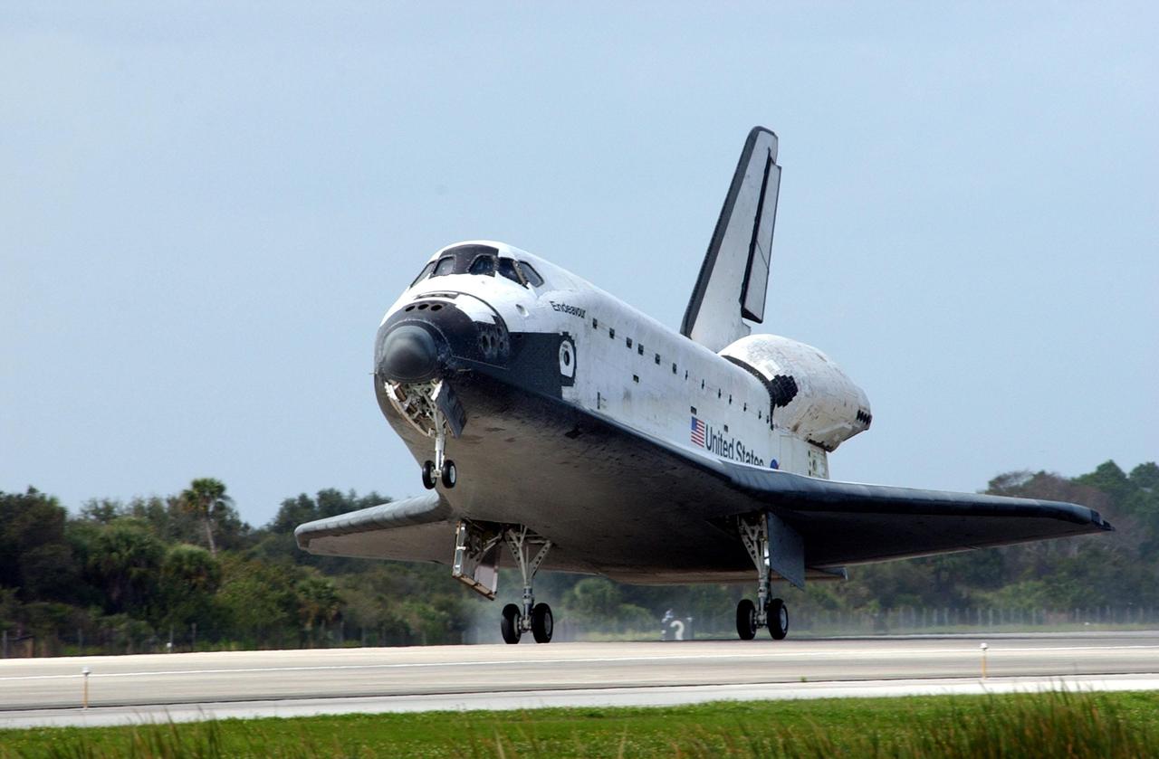 KENNEDY SPACE CENTER, FLA. -- Orbiter Endeavour touches down on Runway 15 at the KSC Shuttle Landing Facility, completing mission STS-108.  After a mission-elapsed time of 11 days, 19 hours and 35 minutes, the landing is the 57th at KSC in the history of the program. Main gear touchdown occurred at 12:55:10 p.m. EST (17:55:10 GMT), nose gear touchdown at 12:55:23 p.m. (17:55:23 GMT) , wheel stop at 12:56:13 p.m. (17:56:13 GMT).   STS-108 was the 12th mission to the International Space Station.  This mission was the 107th flight in the Shuttle program and the 17th flight for the orbiter. Endeavour carries both the mission crew and the Expedition 3 crew - Commander Frank Culbertson and cosmonauts Vladimir Dezhurov and Mikhail Tyurin - who are returning to Earth after 129 days in space on the Space Station