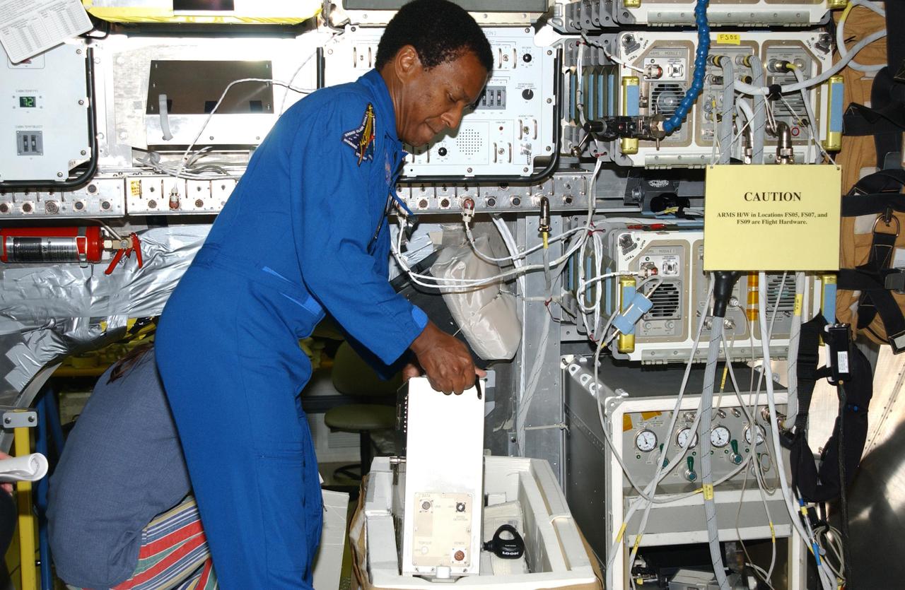 KENNEDY SPACE CENTER, FLA. -- At SPACEHAB in Cape Canaveral, Fla., STS-107 Payload Commander Michael Anderson gets experience on manipulating equipment for the mission. STS-107 is a research mission, and the primary payload is the first flight of the SHI Research Double Module (SHI_RDM). The experiments range from material sciences to life sciences (many rats).  Among the experiments is a Hitchhiker carrier system, modular and expandable in accordance with payload requirements.  STS-107 is scheduled to launch in June 2002