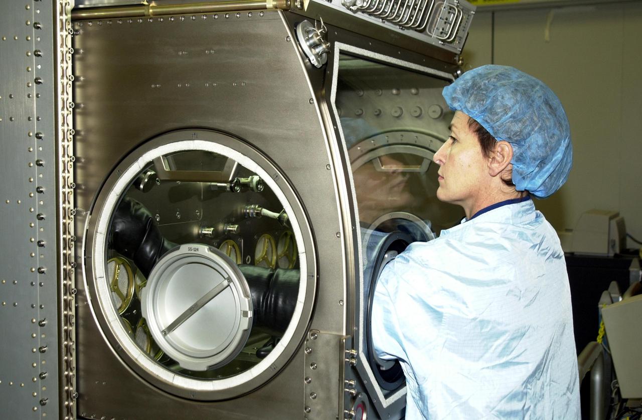 KENNEDY SPACE CENTER, FLA. -- Astronaut Peggy Whitson, a member of the Expedition 5 crew, practices using equipment in the Space Station Processing Facility. She and other crew members Commander Valeri Korzun and Sergei Treschev will be traveling to the International Space Station on mission STS-111 and will be replacing the Expedition 4 crew. Part of the payload on STS-111 will be the Mobile Base System, to be installed installed on the Mobile Transporter to complete the Canadian Mobile Servicing System, or MSS. The mechanical arm will then have the capability to 'inchworm' from the U.S. Lab fixture to the MSS and travel along the Truss to work sites. STS-111 is scheduled to launch in May 2002