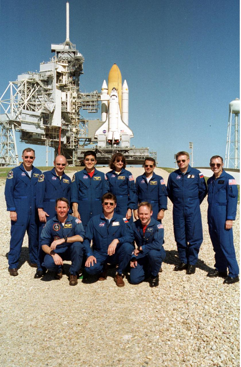 KENNEDY SPACE CENTER, Fla. -- On the launch pad, the STS-108, Expedition 4 and backup crews pause for a photo during Terminal Countdown Demonstration Test activities, which include emergency exit from the launch pad and a simulated launch countdown.  From left, in the back, are STS-108 Commander Dominic L. Gorie, Pilot Mark E. Kelly, and Mission Specialists Daniel M. Tani and Linda A. Godwin; and Expedition 4 crew Daniel W. Bursch, Commander Yuri Onufrienko and Carl E. Walz.   Kneeling in front are Stephen K. Robinson, cosmonaut Gennadi Padalka and E. Michael Fincke.  STS-108 is a Utilization Flight that will carry the replacement Expedition 4 crew to the International Space Station, as well as the Multi-Purpose Logistics Module Raffaello, filled with supplies and equipment.  The l1-day mission is scheduled for launch Nov. 29 on Space Shuttle Endeavour