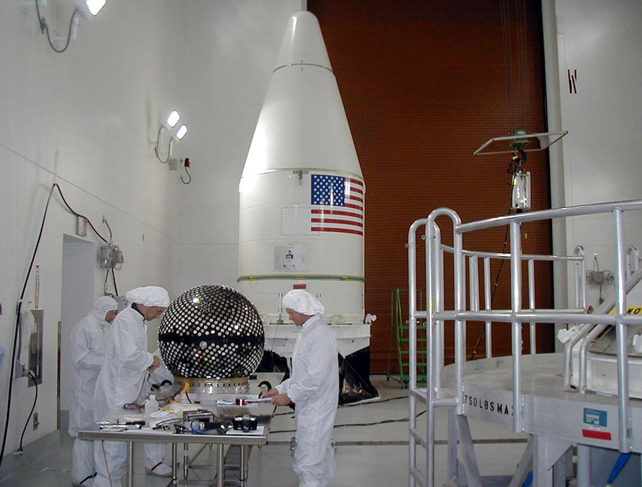 KODIAK ISLAND, Alaska -- Technicians prepare the Starshine 3 payload for its launch aboard the Athena 1 launch vehicle, while the payload fairing awaits processing, at Kodiak Island, Alaska, as preparations to launch Kodiak Star proceed. The first orbital launch to take place from Alaska's Kodiak Launch Complex, Kodiak Star is scheduled to lift off on a Lockheed Martin Athena I launch vehicle on Sept. 17 during a two-hour window that extends from 5:00 to 7:00 p.m. ADT. The payloads aboard include the Starshine 3, sponsored by NASA, and the PICOSat, PCSat and Sapphire, sponsored by the Department of Defense (DoD) Space Test Program.              