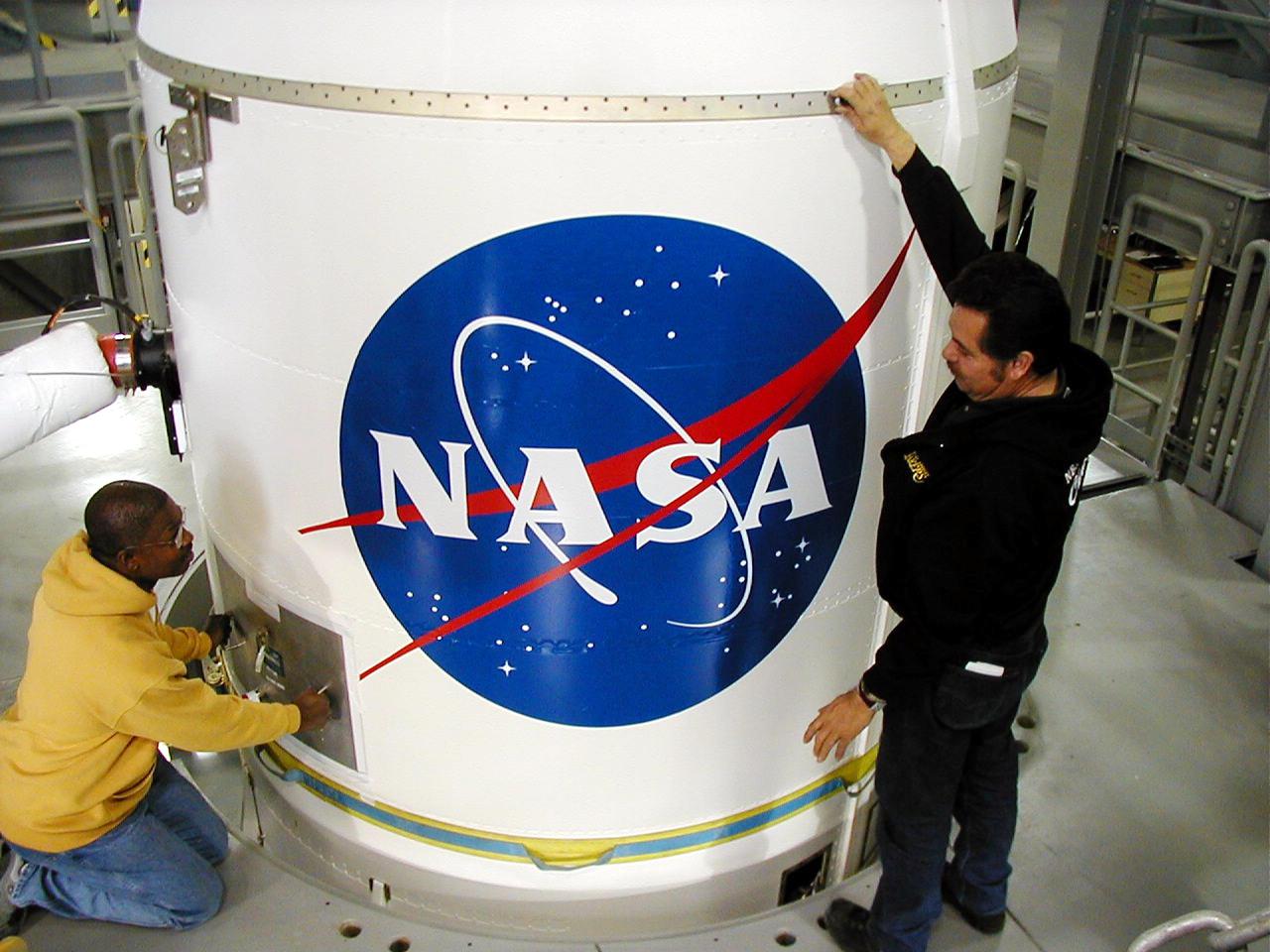 KODIAK ISLAND, ALASKA - A transporter moves the encapsulated Kodiak Star spacecraft into position in the Launch Service Structure, Kodiak Launch Complex (KLC), for final stacking for launch. The first launch to take place from KLC, Kodiak Star is scheduled to lift off on a Lockheed Martin Athena I launch vehicle on Sept. 17 during a two-hour window that extends from 5 p.m. to 7 p.m. p.m. ADT. The payloads aboard include the Starshine 3, sponsored by NASA, and the PICOSat, PCSat and Sapphire, sponsored by the Department of Defense (DoD) Space Test Program. KLC is the newest commercial launch complex in the United States, ideal for launch payloads requiring low-Earth polar or sun-synchronous orbits