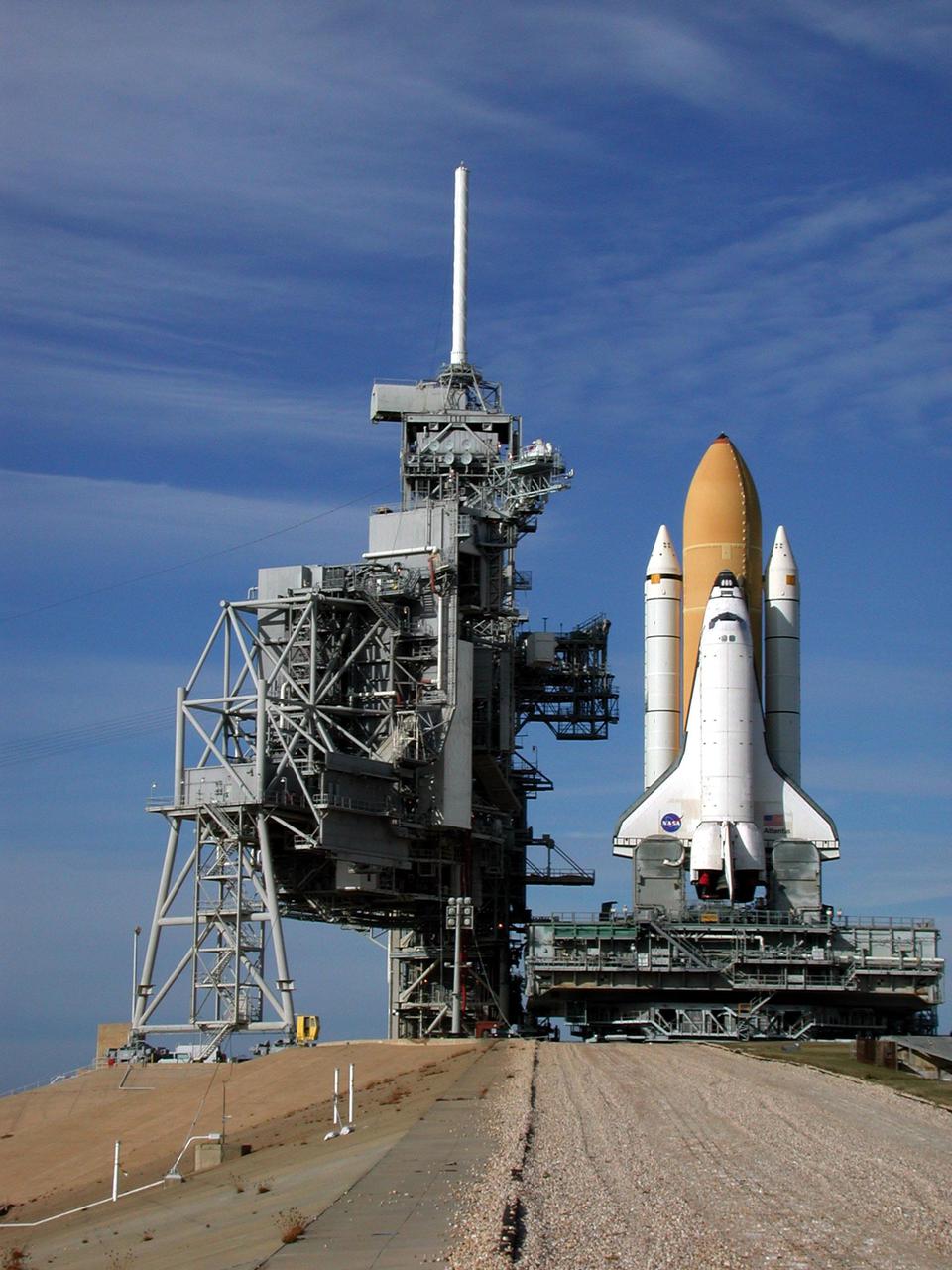KENNEDY SPACE CENTER, Fla. -- At the top of Launch Pad 39A, Space Shuttle Atlantis closes in on the Rotating Service Structure (left). On the RSS, the payload canister can be seen half way up the structure as it is lifted to the Payload Changeout Room. Atlantis will fly on mission STS-98, the seventh construction flight to the International Space Station, carrying the U.S. Laboratory, named Destiny. The lab will have five system racks already installed inside the module. After delivery of electronics in the lab, electrically powered attitude control for Control Moment Gyroscopes will be activated. Atlantis is scheduled for launch no earlier than Jan. 19, 2001, with a crew of five