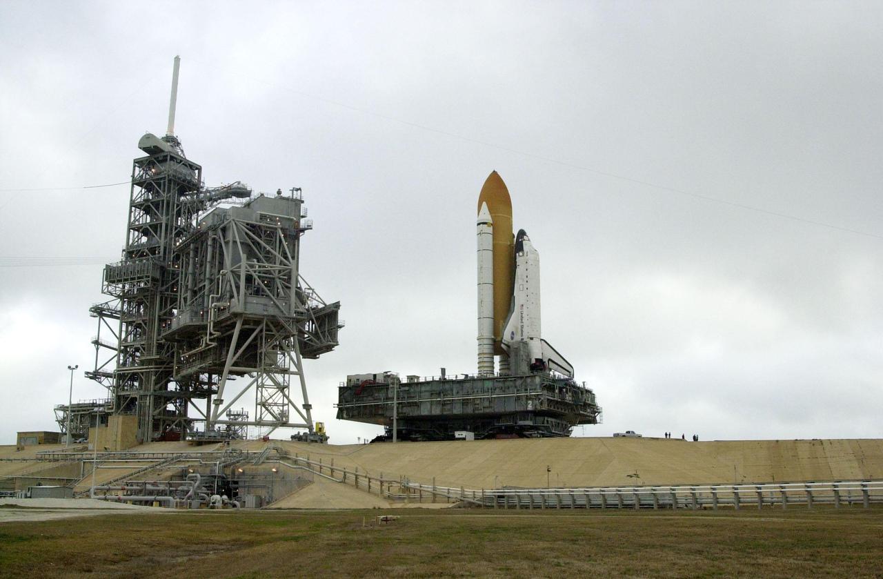 KENNEDY SPACE CENTER, FLA. -- Traveling about 1 mph on the crawler-transporter, Space Shuttle Atlantis begins the 3.4-mile trek back to the Vehicle Assembly Building. In the VAB workers will conduct inspections, make continuity checks and conduct X-ray analysis on the 36 solid rocket booster cables located inside each booster’s system tunnel. An extensive evaluation of NASA’s SRB cable inventory revealed conductor damage in four (of about 200) cables on the shelf. Shuttle managers decided to prove the integrity of the system tunnel cables already on Atlantis before launching Jan. 19. The launch has been rescheduled no earlier than Feb. 6