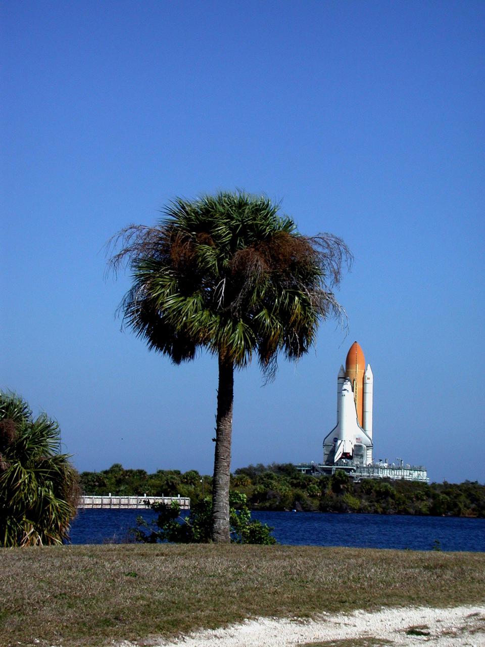 KENNEDY SPACE CENTER, FLA. -- Space Shuttle Atlantis joins blue skies and palm trees on the Florida landscape. Atlantis is rolling back from Launch Pad 39A to the Vehicle Assembly Building so that workers can conduct inspections, make continuity checks and conduct X-ray analysis on the 36 SRB cables located inside each booster’s system tunnel. An extensive evaluation of NASA’s SRB cable inventory revealed conductor damage in four (of about 200) cables on the shelf. Shuttle managers decided to prove the integrity of the system tunnel cables already on Atlantis before launching Jan. 19. The launch has been rescheduled no earlier than Feb. 6