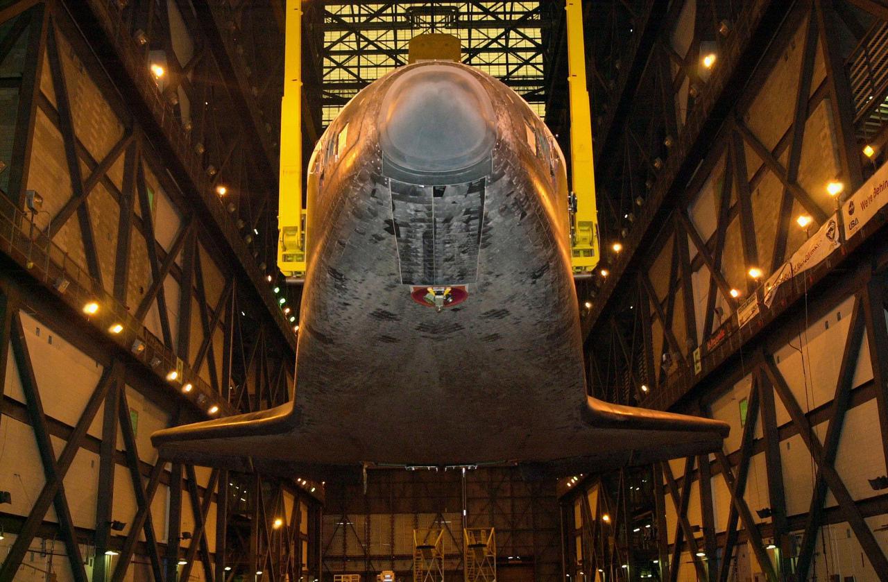 The underside of orbiter Discovery is seen as it is lifted to vertical in the transfer aisle of the Vehicle Assembly Building. It will then be lifted up and into high bay 1 for mating with its solid rocket boosters and external tank. Discovery will be launched March 8 on mission STS-102, the eighth construction flight to the International Space Station. The Shuttle will carry the Multi-Purpose Logistics Module Leonardo, the first of three pressurized modules provided by the Italian Space Agency to carry supplies and equipment to the Space Station and back to earth