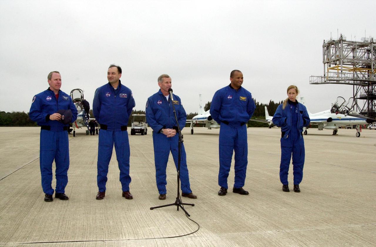 KENNEDY SPACE CENTER, FLA. -- STS-98 Mission Commander Kenneth Cockrell (center at microphone) speaks to the media at the Shuttle Landing Facility after the crew's arrival Sunday to complete preparations for launch.; The crew also includes, from left to right, Mission Specialist Thomas Jones, Pilot Mark Polansky and Mission Specialists Robert Curbeam and Marsha Ivins. STS-98 is the seventh construction flight to the International Space Station, carrying as payload the U.S. Lab Destiny, a key element in the construction of the ISS. Launch of STS-98 is scheduled for Feb. 7 at 6:11 p.m. EST
