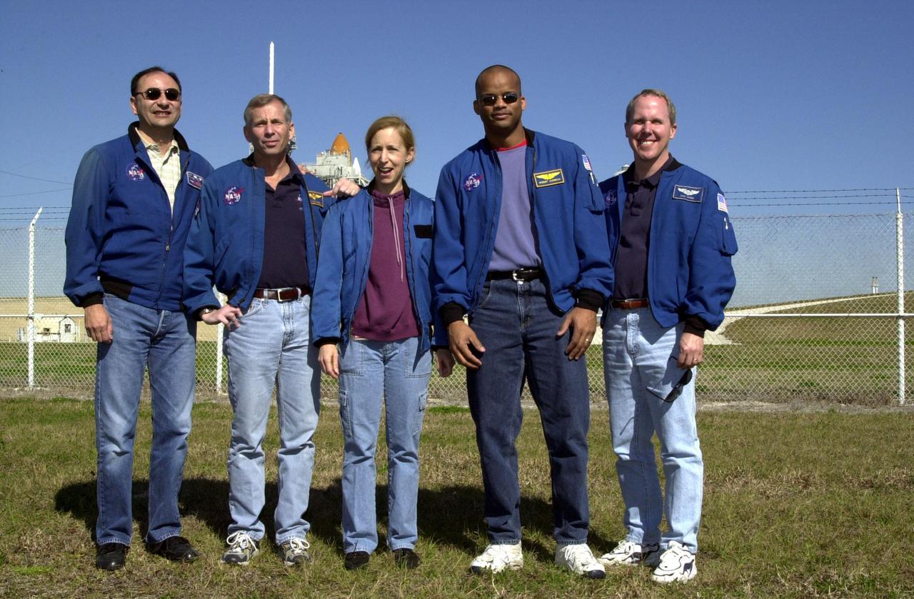 KENNEDY SPACE CENTER, FLA. -- Looking relaxed and happy one day before launch, the STS-98 crew gather at Launch Pad 39A. From left, they are Pilot Mark Polansky, Commander Ken Cockrell and Mission Specialists Marsha Ivins, Robert Curbeam and Thomas Jones. Behind them is Space Shuttle Atlantis, poised for launch. This mission marks the seventh Shuttle flight to the International Space Station and the first Shuttle mission of the year. On the mission, the crew will deliver the U.S. Laboratory Destiny to the growing Space Station. Destiny will be attached to the Unity node using the Shuttle’s robotic arm. Three spacewalks are required to complete the planned construction work. The 11-day STS-98 mission is scheduled to launch Feb. 7 at 6:11 p.m. EST, with a planned KSC landing about 1:39 p.m. on Feb. 18