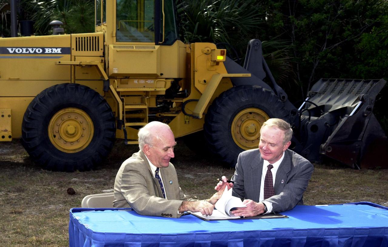 Ed Gormel (left), executive director of Spaceport Florida Authority, and Roy Bridges Jr., Center Director, get ready to sign a SERPL Real Property Use Permit Agreement between the two organizations to construct a three-mile roadway. It is the start of a construction project that includes the Space Experiment Research and Processing Laboratory (SERPL). The signing took place outdoors on S.R. 3 prior to a groundbreaking ceremony for the roadway. The road, to be known as Space Commerce Way, will serve the public by providing a 24-hour access route through KSC from S.R. 3 to the NASA Causeway and KSC Visitor Complex. The SERPL project is enabled by a partnership and collaboration between NASA and the State of Florida to create a vital resource for international and commercial space customers. SERPL is considered a magnet facility, and will support the development and processing of life sciences experiments destined for the International Space Station and accommodate NASA, industry and academic researchers performing associated biological research