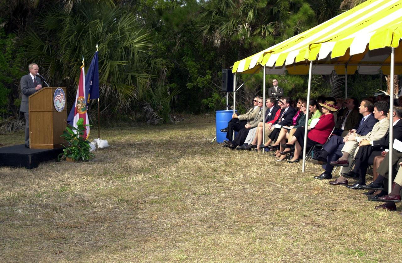 Center Director Roy Bridges Jr. addresses attendees at a groundbreaking ceremony held on S.R. 3. The groundbreaking is for a roadway, to be known as Space Commerce Way, that will serve the public by providing a 24-hour access route through KSC from S.R. 3 to the NASA Causeway and KSC Visitor Complex. It is the start of a construction project that includes the Space Experiment Research and Processing Laboratory (SERPL). The project is enabled by a partnership and collaboration between NASA and the State of Florida to create a vital resource for international and commercial space customers. Among the participants and guests seated under the tent are (in front row, at right) Florida’s Lt. Gov. Frank Brogan and Congressman Dave Weldon. SERPL is considered a magnet facility, and will support the development and processing of life sciences experiments destined for the International Space Station and accommodate NASA, industry and academic researchers performing associated biological research