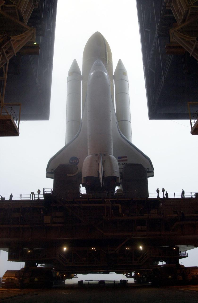 KENNEDY SPACE CENTER, Fla. -- Against a fog-filled sky, Space Shuttle Discovery starts rolling out of the Vehicle Assembly Building to Launch Pad 39B. Discovery will fly on mission STS-102 to the International Space Station. Its payload is the Multi-Purpose Logistics Module Leonardo, a “moving vans,” to carry laboratory racks filled with equipment, experiments and supplies to and from the Space Station aboard the Space Shuttle. The flight will also carry the Expedition Two crew up to the Space Station, replacing Expedition One, who will return to Earth on Discovery. Launch is scheduled for March 8 at 6:45 a.m. EST