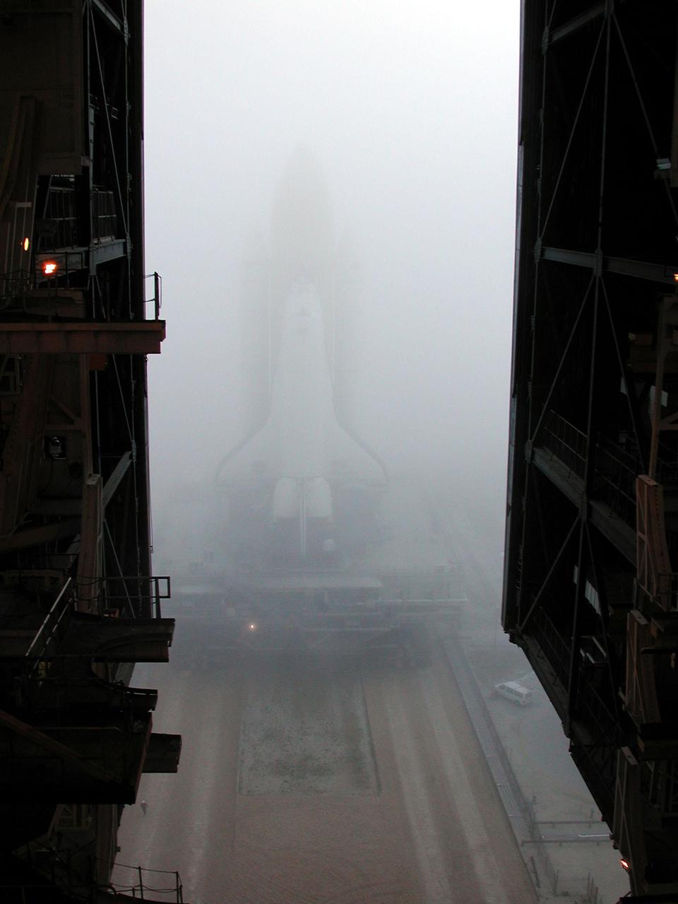 KENNEDY SPACE CENTER, Fla. -- An early morning fog that shrouds Kennedy Space Center almost renders Space Shuttle Discovery invisible as it rolls out from the Vehicle Assembly Building to Launch Pad 39B and mission STS-102 to the International Space Station. Its payload is the Multi-Purpose Logistics Module Leonardo, a “moving van,” to carry laboratory racks filled with equipment, experiments and supplies to and from the Space Station aboard the Space Shuttle. The flight will also carry the Expedition Two crew up to the Space Station, replacing Expedition One, who will return to Earth on Discovery.  Launch is scheduled for March 8 at 6:45 a.m. EST