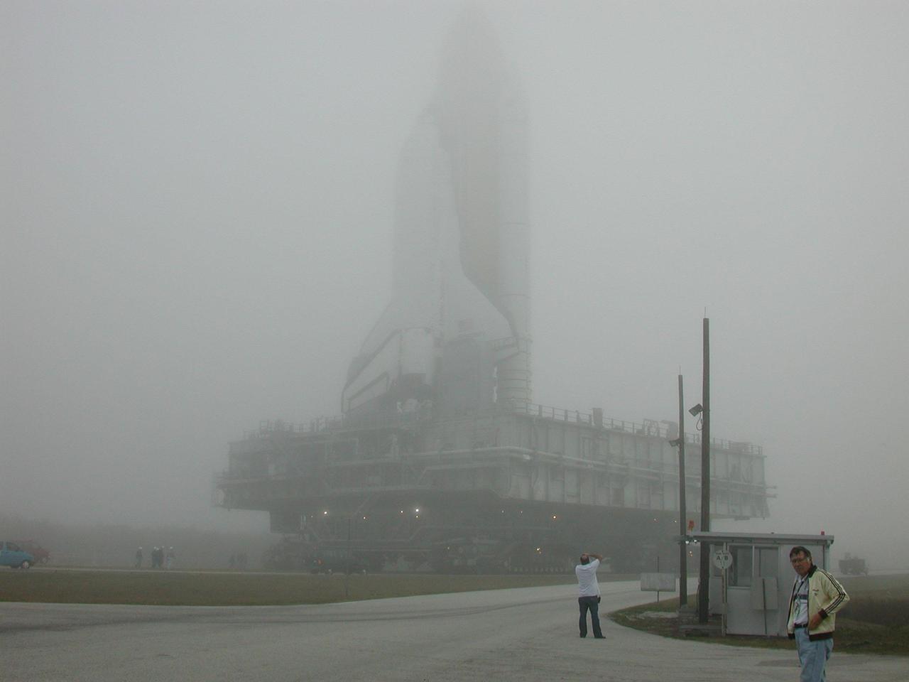 KENNEDY SPACE CENTER, Fla. -- Fog-enshrouded Space Shuttle Discovery dwarfs the workers on the ground as it crawls to Launch Pad 39B. Discovery will be flying on mission STS-102 to the International Space Station. Its payload is the Multi-Purpose Logistics Module Leonardo, a “moving van,” to carry laboratory racks filled with equipment, experiments and supplies to and from the Space Station aboard the Space Shuttle. The flight will also carry the Expedition Two crew up to the Space Station, replacing Expedition One, who will return to Earth on Discovery. Launch is scheduled for March 8 at 6:45 a.m. EST