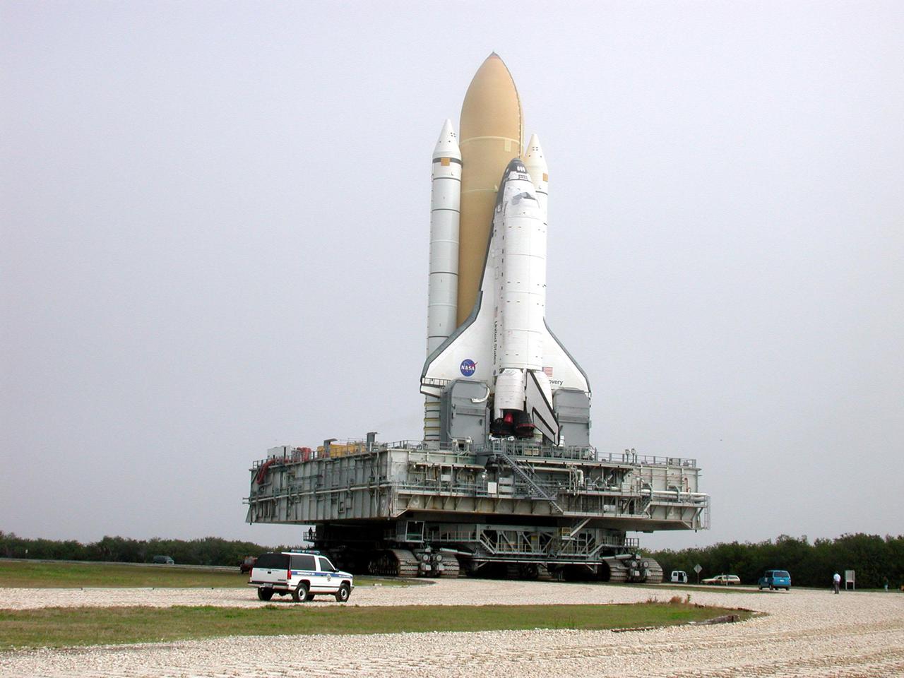 KENNEDY SPACE CENTER, Fla. -- Fog-enshrouded Space Shuttle Discovery dwarfs the workers on the ground as it crawls to Launch Pad 39B. Discovery will be flying on mission STS-102 to the International Space Station. Its payload is the Multi-Purpose Logistics Module Leonardo, a “moving van,” to carry laboratory racks filled with equipment, experiments and supplies to and from the Space Station aboard the Space Shuttle. The flight will also carry the Expedition Two crew up to the Space Station, replacing Expedition One, who will return to Earth on Discovery. Launch is scheduled for March 8 at 6:45 a.m. EST