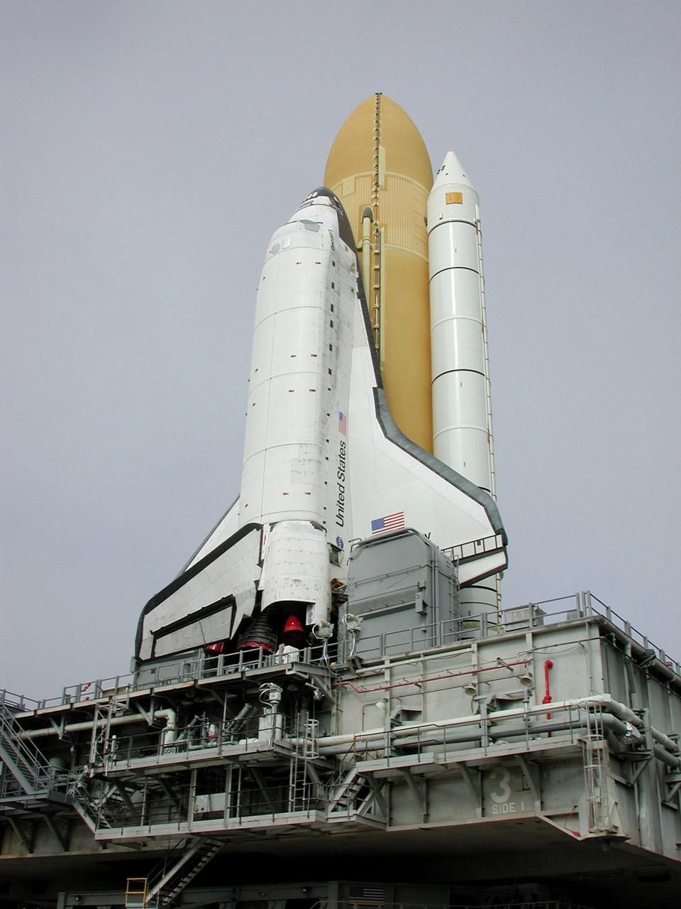 KENNEDY SPACE CENTER, Fla. -- This closeup shows Space Shuttle Discovery as it travels to Launch Pad 39B. Underneath Discovery is the Mobile Launcher Platform, a two-story movable launch base. Part of the MPLM is the tail service mast, seen here at the bottom of the wind and next to the Shuttle’s main engines. The tail service mast is 31 feet high, 15 feet long and 9 feet wide. A second TSM is on the other side. They support the fluid, gas and electrical requirements of the orbiter’s liquid oxygen and liquid hydrogen aft T-0 umbilicals. Discovery will be flying on mission STS-102 to the International Space Station. Its payload is the Multi-Purpose Logistics Module Leonardo, a “moving van,” to carry laboratory racks filled with equipment, experiments and supplies to and from the Space Station aboard the Space Shuttle. The flight will also carry the Expedition Two crew up to the Space Station, replacing Expedition One, who will return to Earth on Discovery. Launch is scheduled for March 8 at 6:45 a.m. EST