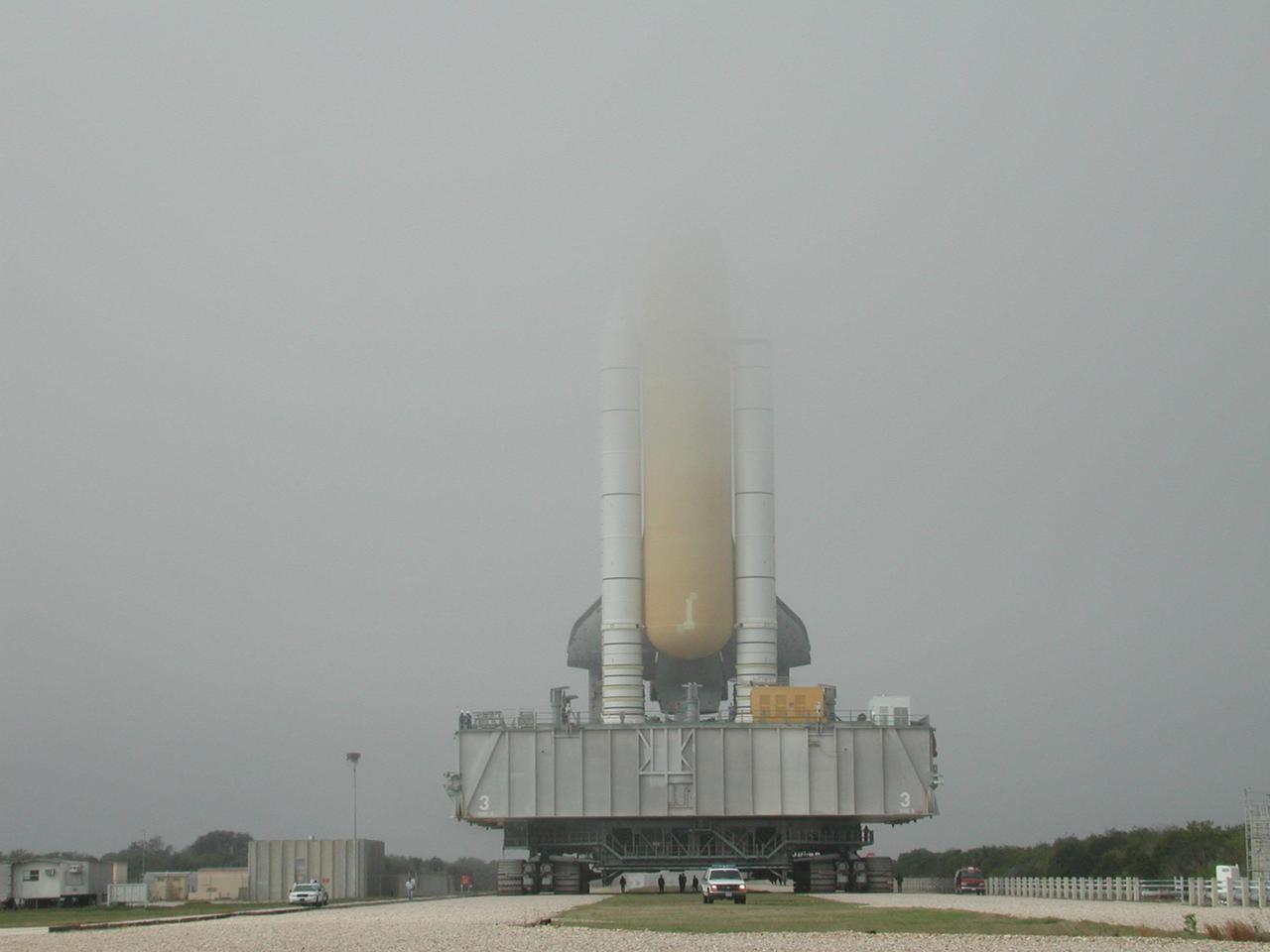 KENNEDY SPACE CENTER, Fla. -- As Space Shuttle Discovery, on its Mobile Launcher Platform, nears Launch Pad 39B, fog rolls over the top of the external tank and solid rocket boosters. Discovery will be flying on mission STS-102 to the International Space Station. Its payload is the Multi-Purpose Logistics Module Leonardo, a “moving van,” to carry laboratory racks filled with equipment, experiments and supplies to and from the Space Station aboard the Space Shuttle. The flight will also carry the Expedition Two crew up to the Space Station, replacing Expedition One, who will return to Earth on Discovery. Launch is scheduled for March 8 at 6:45 a.m. EST