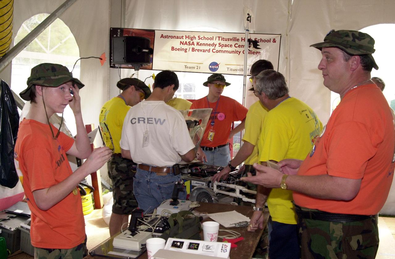 Getting ready for preliminary heats, students from Astronaut and Titusville High Schools work on their robot to compete in the NASA_KSC FIRST Southeastern Regional event.  FIRST (For Inspiration and Recognition of Science and Technology) events are held nationwide, pitting the student-built robots against each other and the clock on a playing field.  Many teams are sponsored by corporations and academic institutions.  There are 27 teams throughout the State of Florida who are competing.  KSC, which sponsors nine teams, has held the regional event for two years.