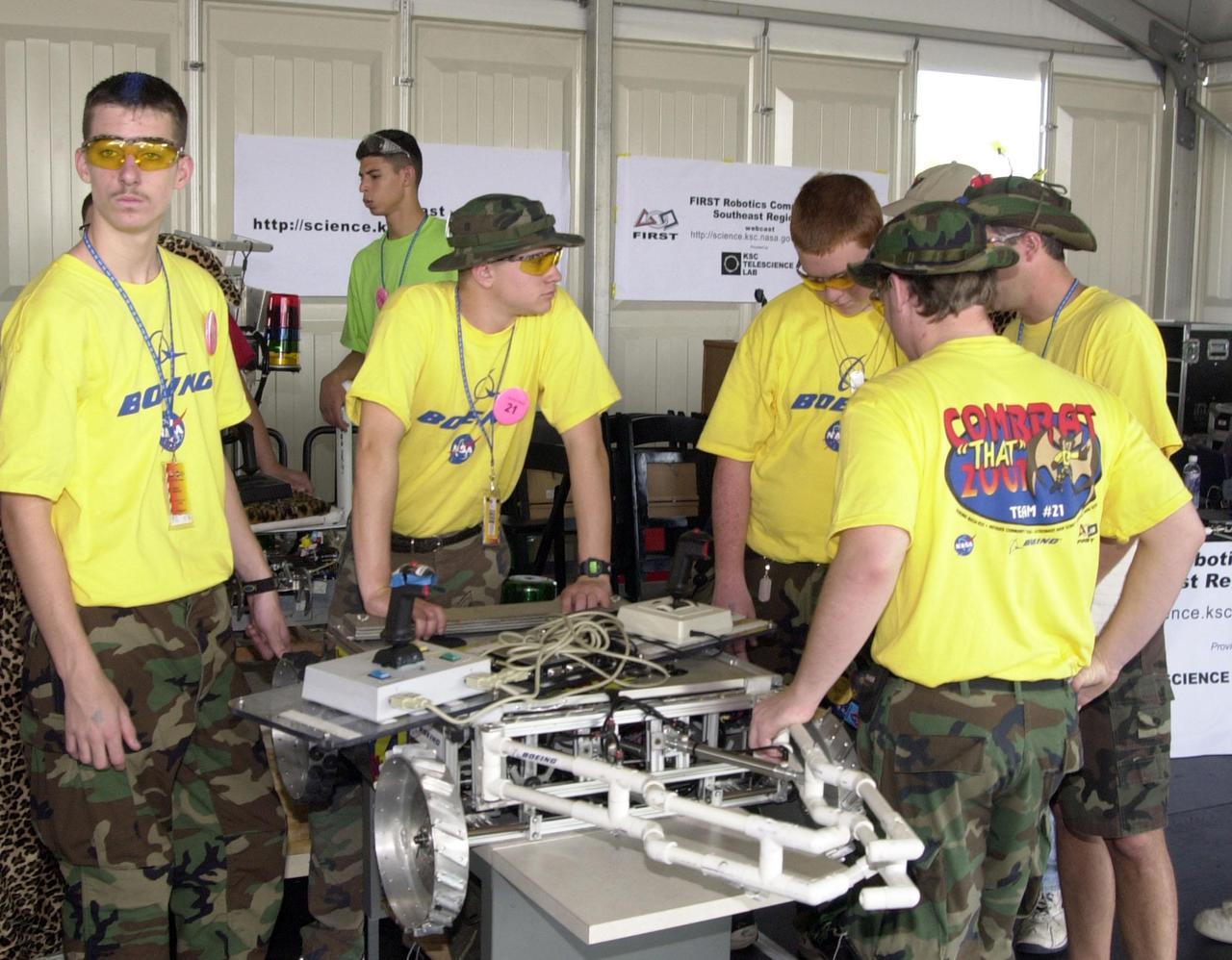 During the NASA_KSC FIRST Southeastern Regional competition held March 1-3, 2001, the ComBBAT 2001 team gives a final check to their robot. ComBBAT is a KSC joint-sponsored team of students from Astronaut and Titusville High Schools, Florida. FIRST (For Inspiration and Recognition of Science and Technology) events are held nationwide, pitting robots against each other and the clock on a playing field. Many teams are sponsored by corporations and academic institutions. There are 27 teams throughout the State of Florida who are competing. KSC, which sponsors nine teams, has held the regional event for two years