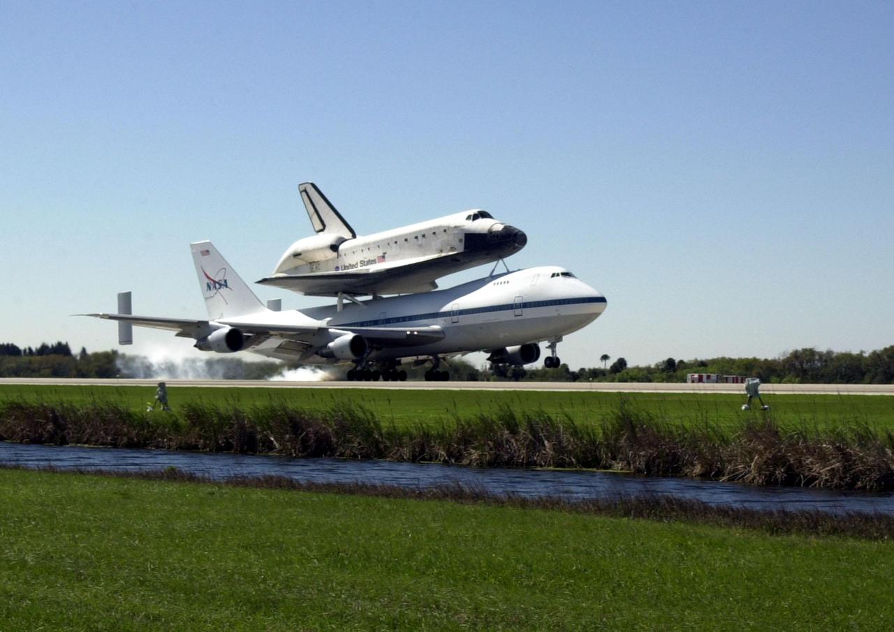 KENNEDY SPACE CENTER, FLA. -- The Shuttle Carrier Aircraft, a modified Boeing 747, kicks up dust as it lands at KSC’s Shuttle Landing Facility with the orbiter Atlantis on top. Atlantis landed in California Feb. 19 concluding mission STS-98. The ferry flight began in California March 1; unfavorable weather conditions kept it on the ground at Altus AFB, Okla., until it could return to Florida. The orbiter will next fly on mission STS-104, the 10th construction flight to the International Space Station, scheduled June 8