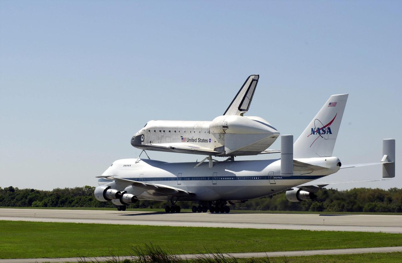 KENNEDY SPACE CENTER, FLA. -- The Shuttle Carrier Aircraft, with its piggyback cargo the orbiter Atlantis, turns on the runway after landing at the KSC Shuttle Landing Facility. The modified Boeing 747 will head to the mate_demate device to have Atlantis removed from its perch. Atlantis landed in California Feb. 19 concluding mission STS-98. The ferry flight began in California March 1; unfavorable weather conditions kept it on the ground at Altus AFB, Okla., until it could return to Florida. The orbiter will next fly on mission STS-104, the 10th construction flight to the International Space Station, scheduled June 8