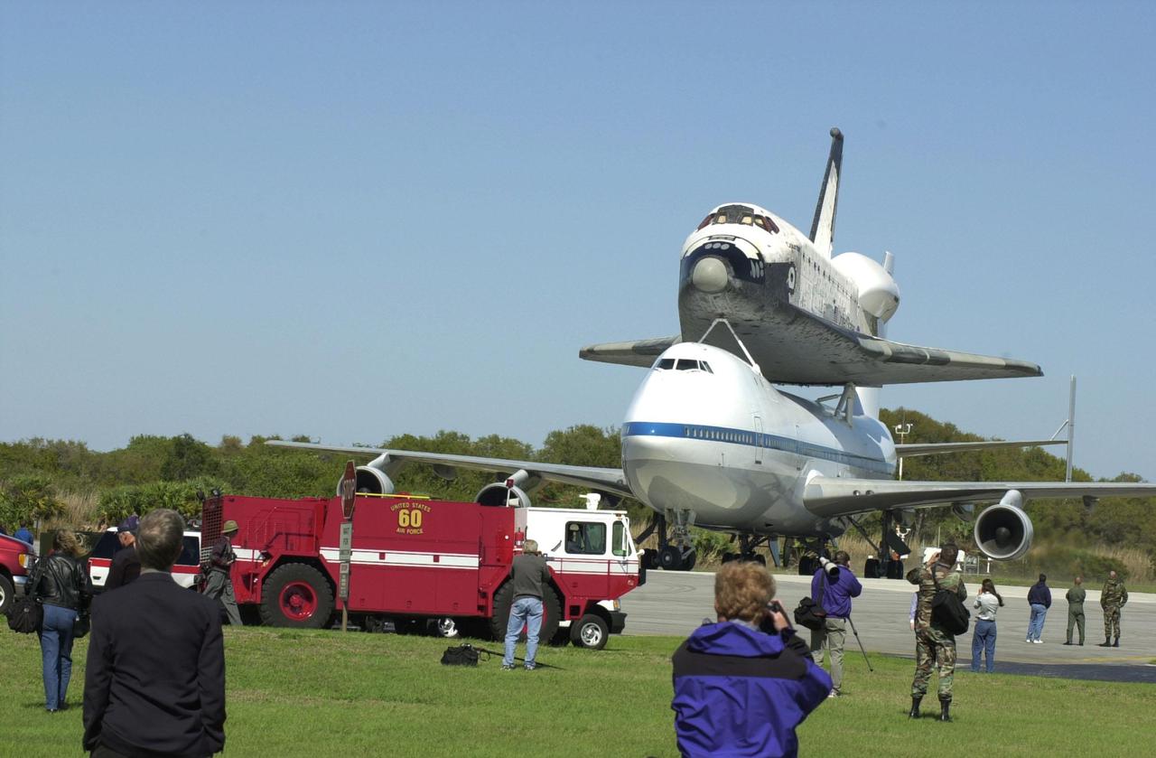 KENNEDY SPACE CENTER, FLA. -- A firetruck stands by as the Shuttle Carrier Aircraft with its cargo the orbiter Columbia comes to a stop at the Cape Canaveral Air Force Station Skid Strip. Columbia’s ferry flight began in California March 1. Unfavorable weather conditions kept it on the ground at Dyess AFB, Texas, until it could return to Florida. Columbia is returning from a 17-month-long modification and refurbishment process as part of a routine maintenance plan. The orbiter will next fly on mission STS-107, scheduled Oct. 25
