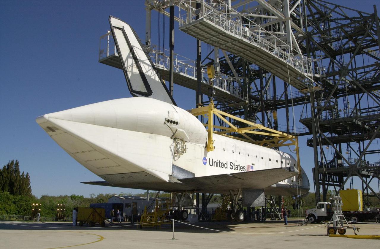 KENNEDY SPACE CENTER, FLA. -- An overhead crane in the mate_demate device at the Shuttle Landing Facility lowers the orbiter Atlantis onto its wheels. A tail cone covers the aft engines. Atlantis was removed from the back of a Shuttle Carrier Aircraft after a ferry flight from California. Atlantis landed Feb. 19 at Edwards Air Force Base concluding mission STS-98. The ferry flight began March 1; unfavorable weather conditions kept it on the ground at Altus AFB, Okla., until it could return to Florida. Atlantis will be transported to the Orbiter Processing Facility to prepare it for mission STS-104, the 10th construction flight to the International Space Station, scheduled to launch June 8