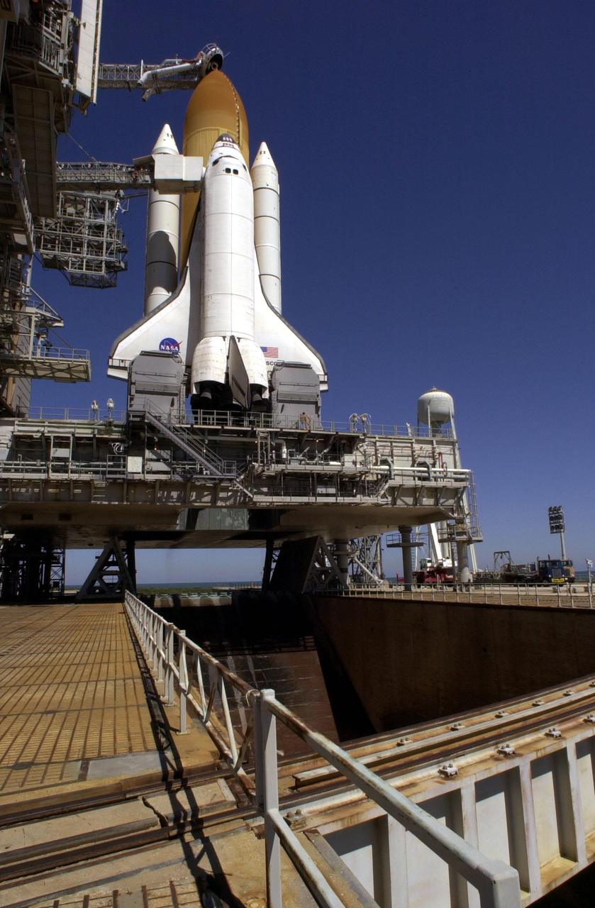 KENNEDY SPACE CENTER, Fla. -- With the Rotating Service Structure rolled back, Space Shuttle Discovery is revealed, poised for launch on mission STS-102 at 6:42 a.m. EST March 8. It sits on the Mobile Launcher Platform, which straddles the flame trench below that helps deflect the intense heat of launch. Made of concrete and refractory brick, the trench is 490 feet long, 58 feet wide and 40 feet high. Situated above the external tank is the Gaseous Oxygen Vent Arm with the “beanie cap,” a vent hood. On this eighth construction flight to the International Space Station, Discovery carries the Multi-Purpose Logistics Module Leonardo, the primary delivery system used to resupply and return Station cargo requiring a pressurized environment. Leonardo will deliver up to 10 tons of laboratory racks filled with equipment, experiments and supplies for outfitting the newly installed U.S. Laboratory Destiny