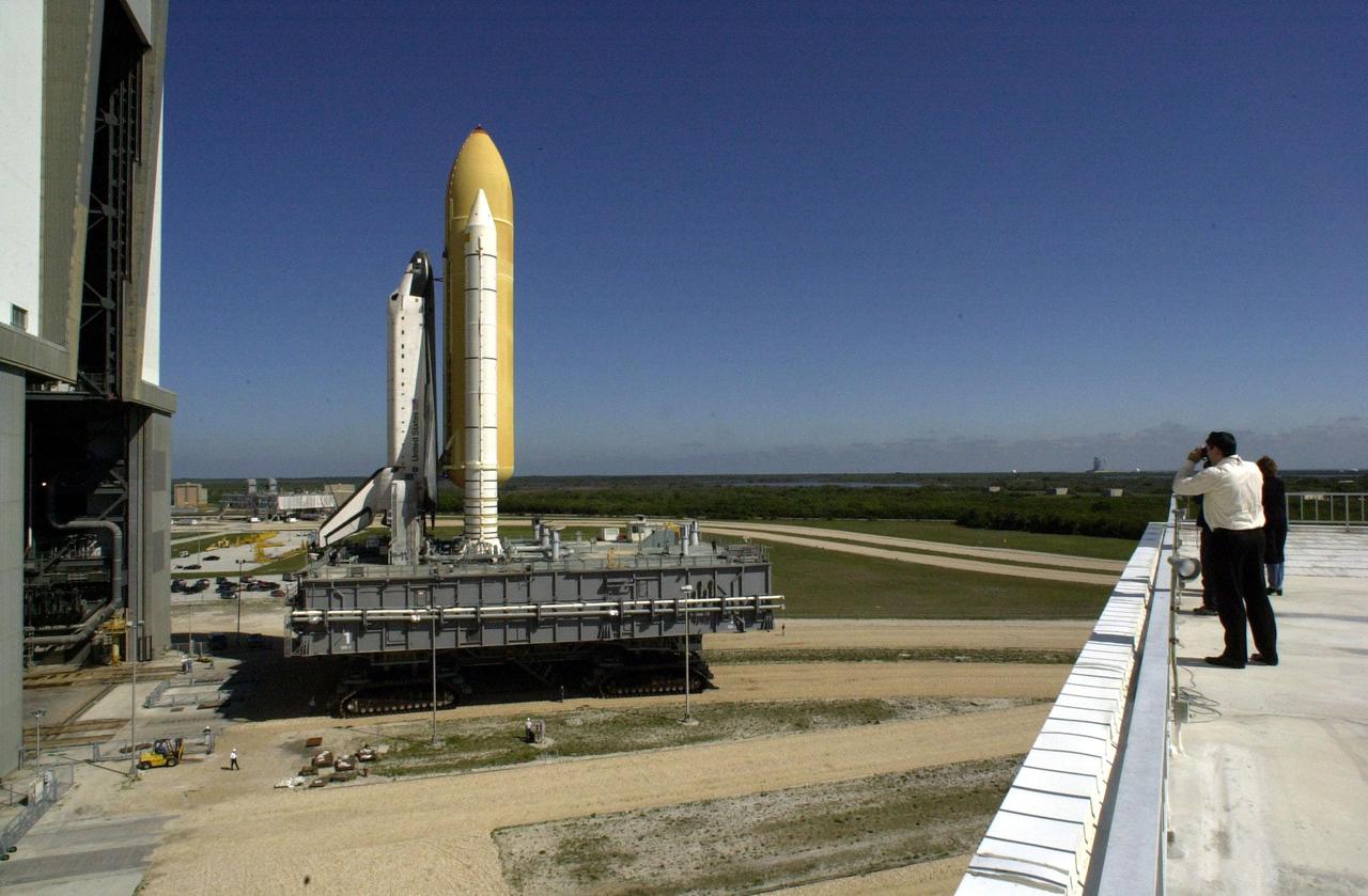 KENNEDY SPACE CENTER, Fla. -- Space Shuttle Endeavour leaves the Vehicle Assembly Building high bay 3 (open door) atop a Mobile Launcher Platform and begins rolling to Launch Pad 39A via a crawler-transporter. The combined height of the Shuttle, MLP and transporter is 235.2 ft. (71.6 m). Once at the pad, routine launch pad validations will commence, verifying all vehicle and facility interfaces. Endeavour is expected to lift off on mission STS-100 on April 19, carrying the Multi-Purpose Logistics Module Raffaello and the Canadian robotic arm, SSRMS, to the International Space Station