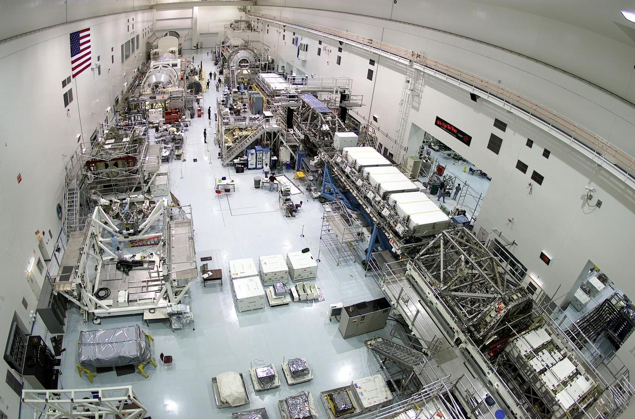 KENNEDY SPACE CENTER, FLA. -- This long view in the Space Station Processing Facility shows the lineup of elements in various stages of preparation for future flights. In the middle of the floor are white boxes housing storage gas tanks. Part of the STS-104 payload, the two gaseous oxygen and two gaseous nitrogen tanks comprise the high pressure gas assembly that will be attached to the Joint Airlock Module during two spacewalks. The tanks will support future spacewalk operations from the Station and augment the Service Module gas resupply system. For launch, scheduled no earlier than June 14 at 4:11 p.m. EDT, the tanks will be placed on the Spacelab Logistics Double Pallet at left
