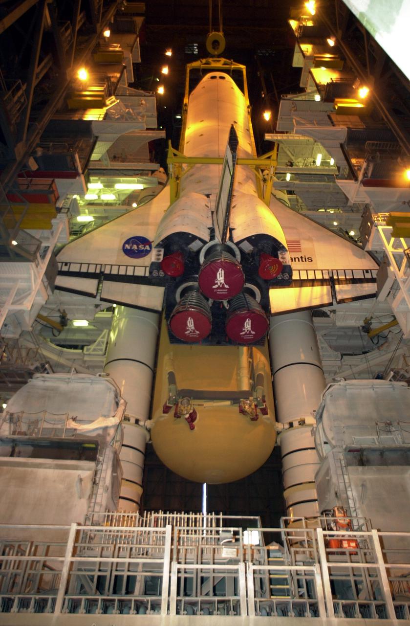 KENNEDY SPACE CENTER, FLA. -- In Vehicle Assembly Building high bay 1, the orbiter Atlantis is being lowered into position for mating to its external tank_solid rocket booster stack.; Space Shuttle Atlantis is scheduled to launch on mission STS-104 in early July