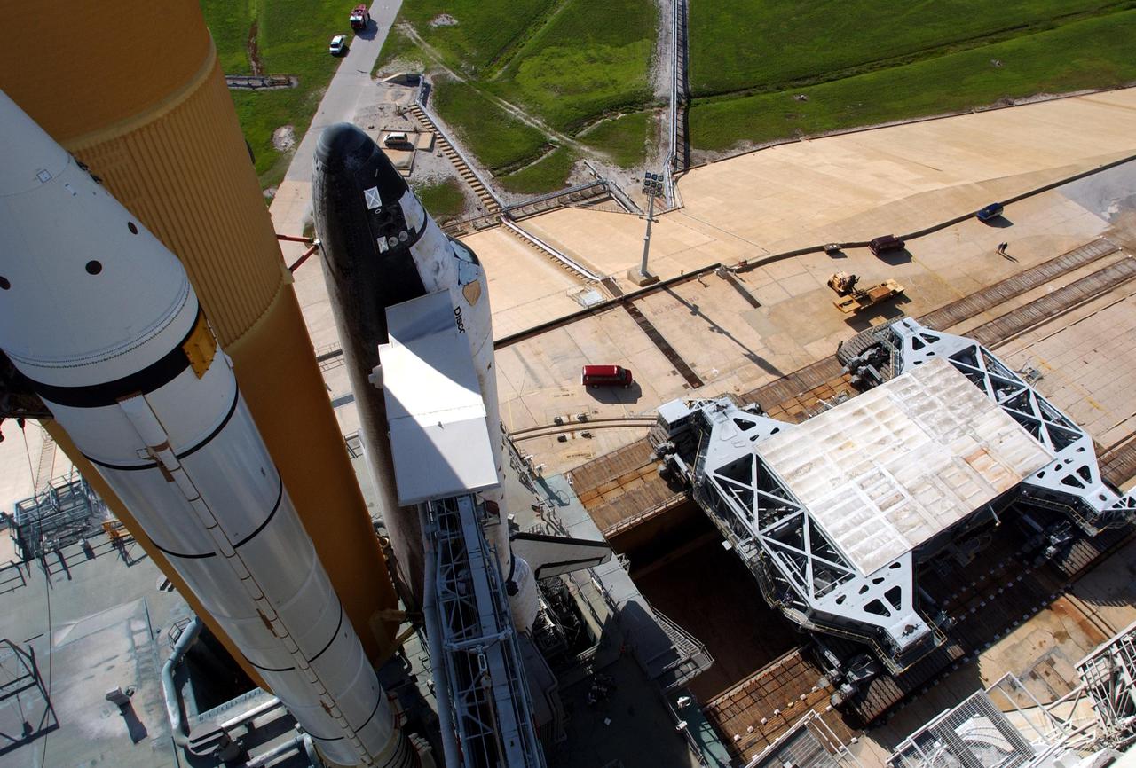KENNEDY SPACE CENTER, Fla. -- This high-level view shows the crawler transporter (right) as it is backing away from Space Shuttle Atlantis and the mobile launcher platform (MLP) on Launch Pad 39A. The crawler transporter moved the Shuttle atop the MLP from the Vehicle Assembly Building to the pad in about six hours. Discovery is scheduled to launch in early August on mission STS-105. Photo by Scott Andrews using a Nikon D1X camera